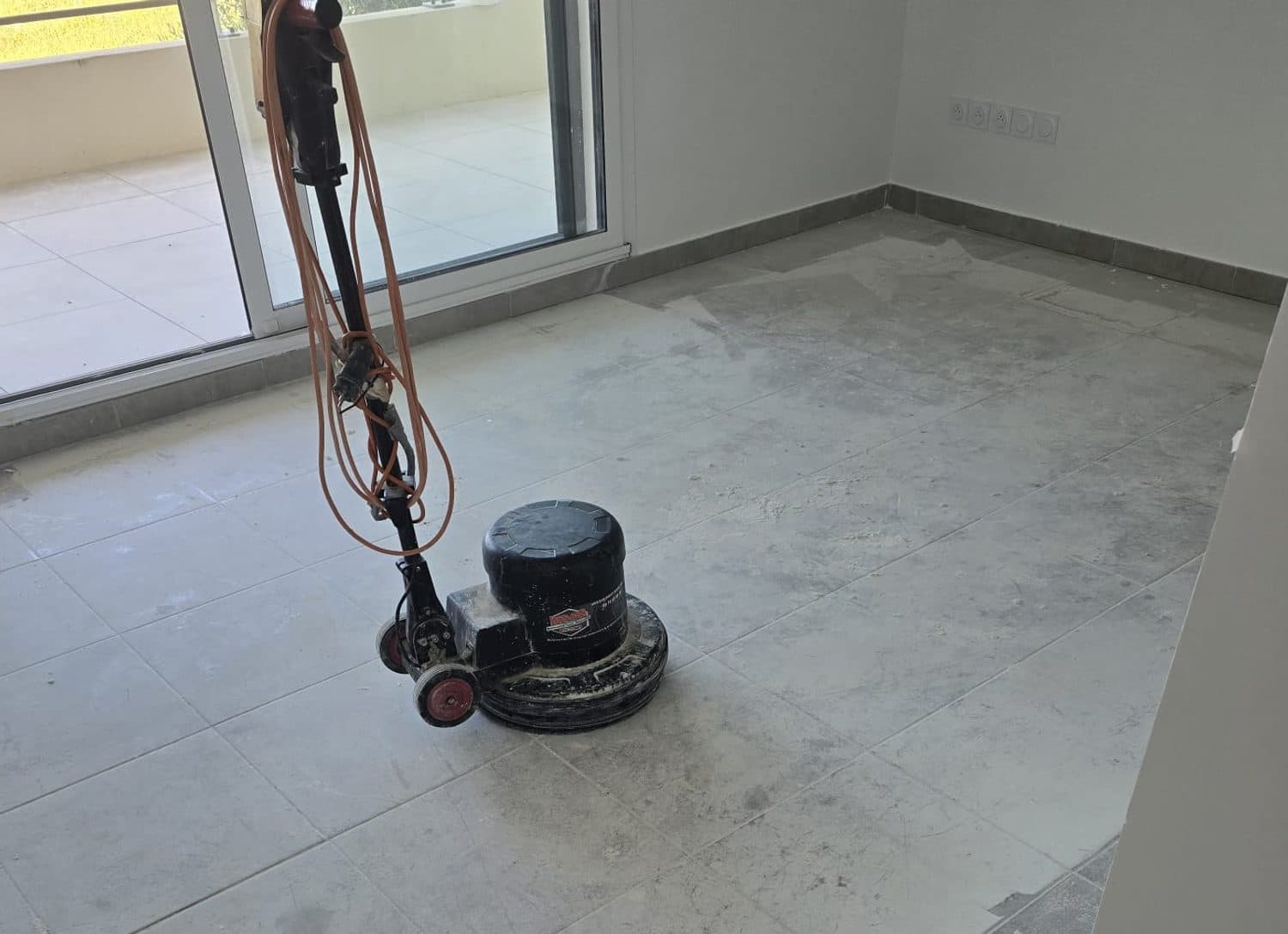 Monobrosse de Clean Home décapant un carrelage encore couvert de laitance